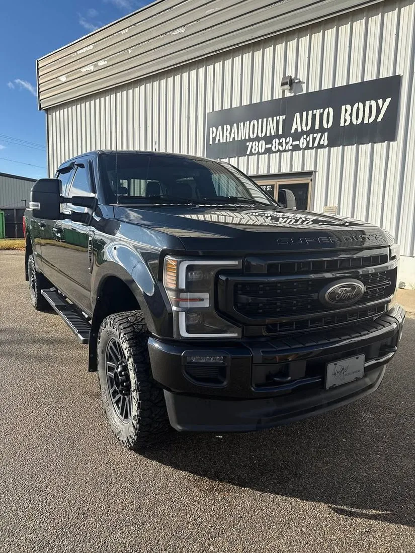Blacked-out Ford F-250 Super Duty outside Paramount Auto Body in Grande Prairie