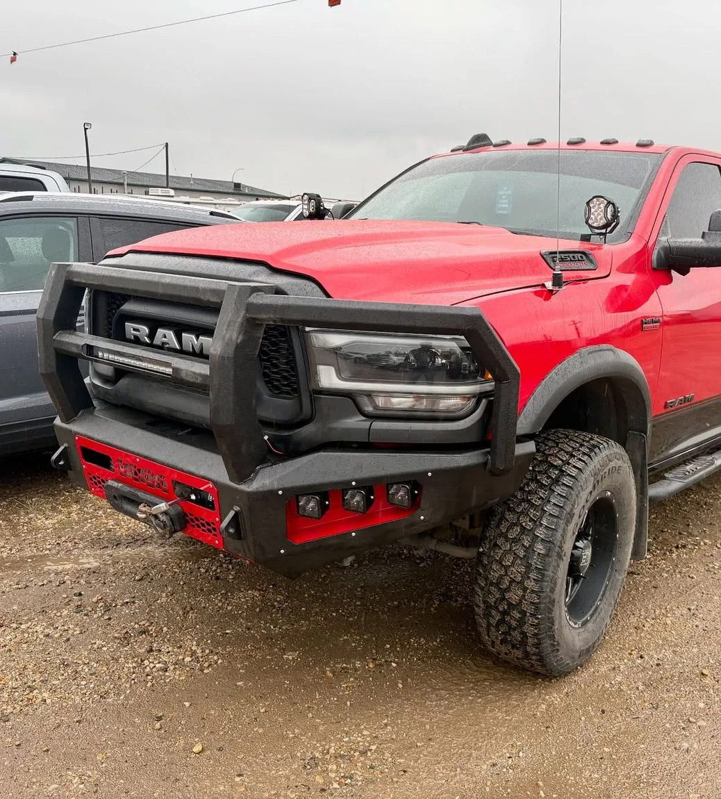 Lifted RAM Power Wagon with custom bumper at a Grande Prairie body shop